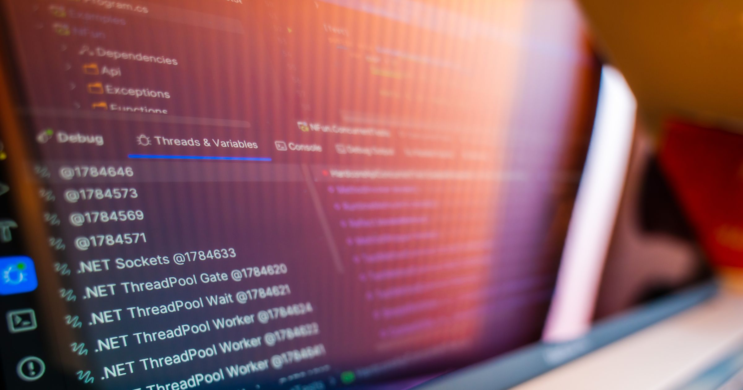 A clean workstation desk displaying system logs and code execution figures on a monitor.